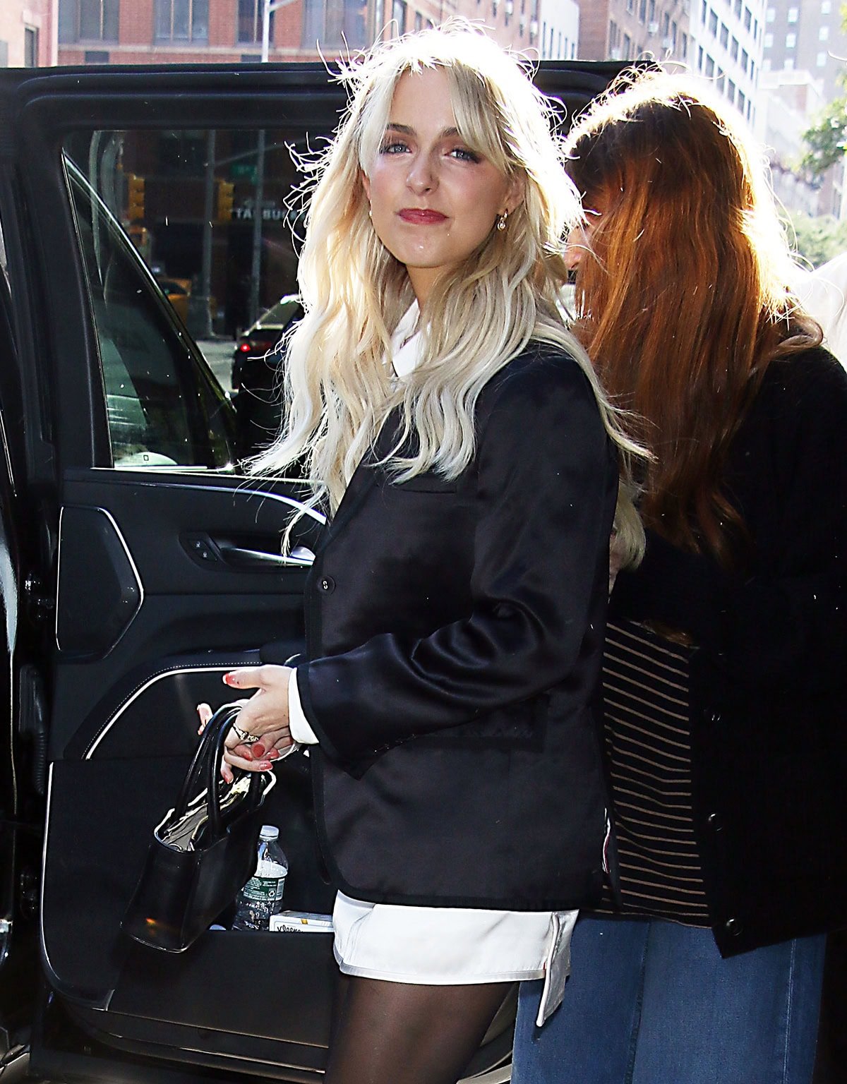 Flashing a bright smile, McKenna showcases her soft glam waves and minimal jewelry while heading to her car after the interview
