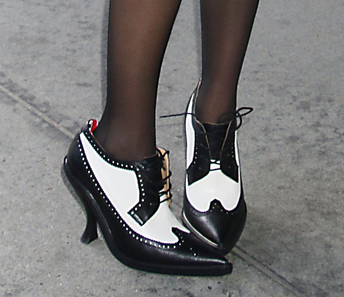 A close-up of McKenna’s black-and-white Thom Browne spectator brogues reveals the curved heels, wingtip detailing, and signature grosgrain tab