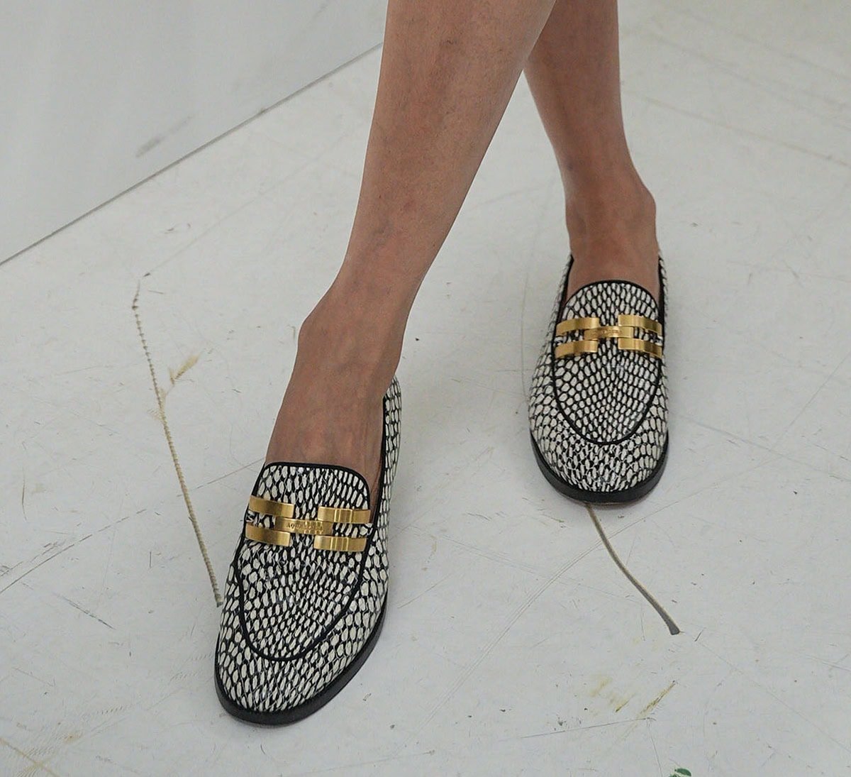 Olivia Palermo parades her legs in Aquazzura's Brandi loafers in striking black-and-white snakeskin with a gold-tone buckle