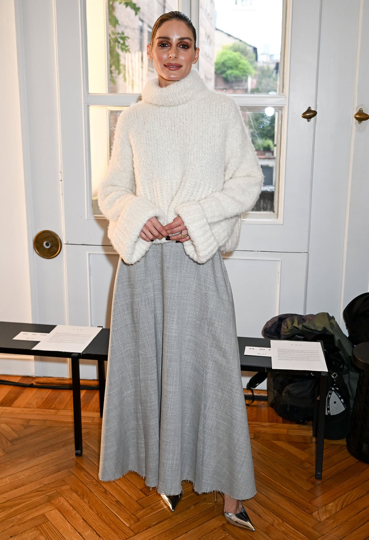 Olivia Palermo graces the front row at Sa Su Phi's Spring/Summer 2026 fashion presentation in an ivory Teddy sweater and a light gray wool skirt