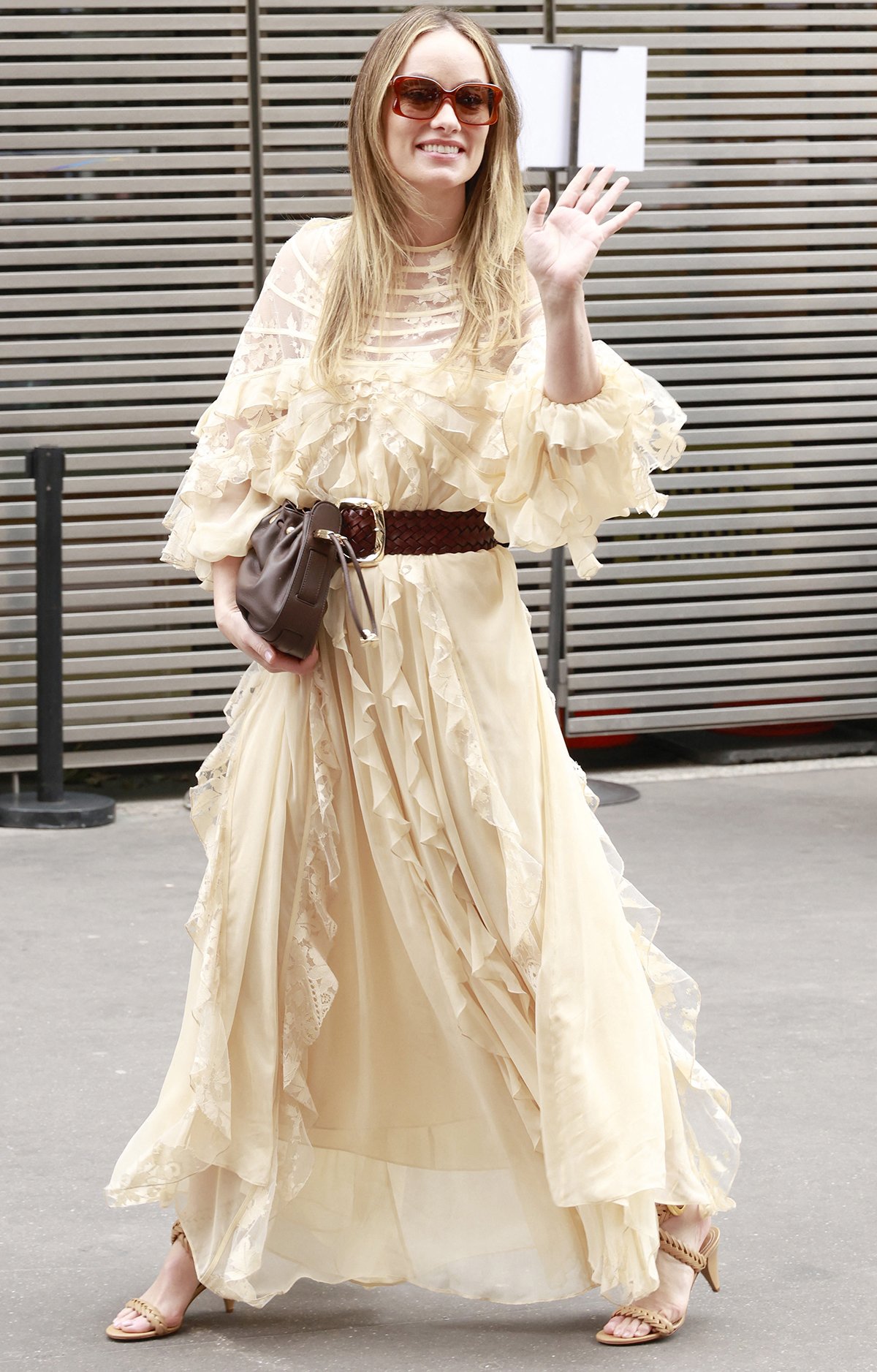 Olivia Wilde channels her inner boho princess in an ivory Zimmermann tiered dress with sheer floral lace panels and ruffle trims