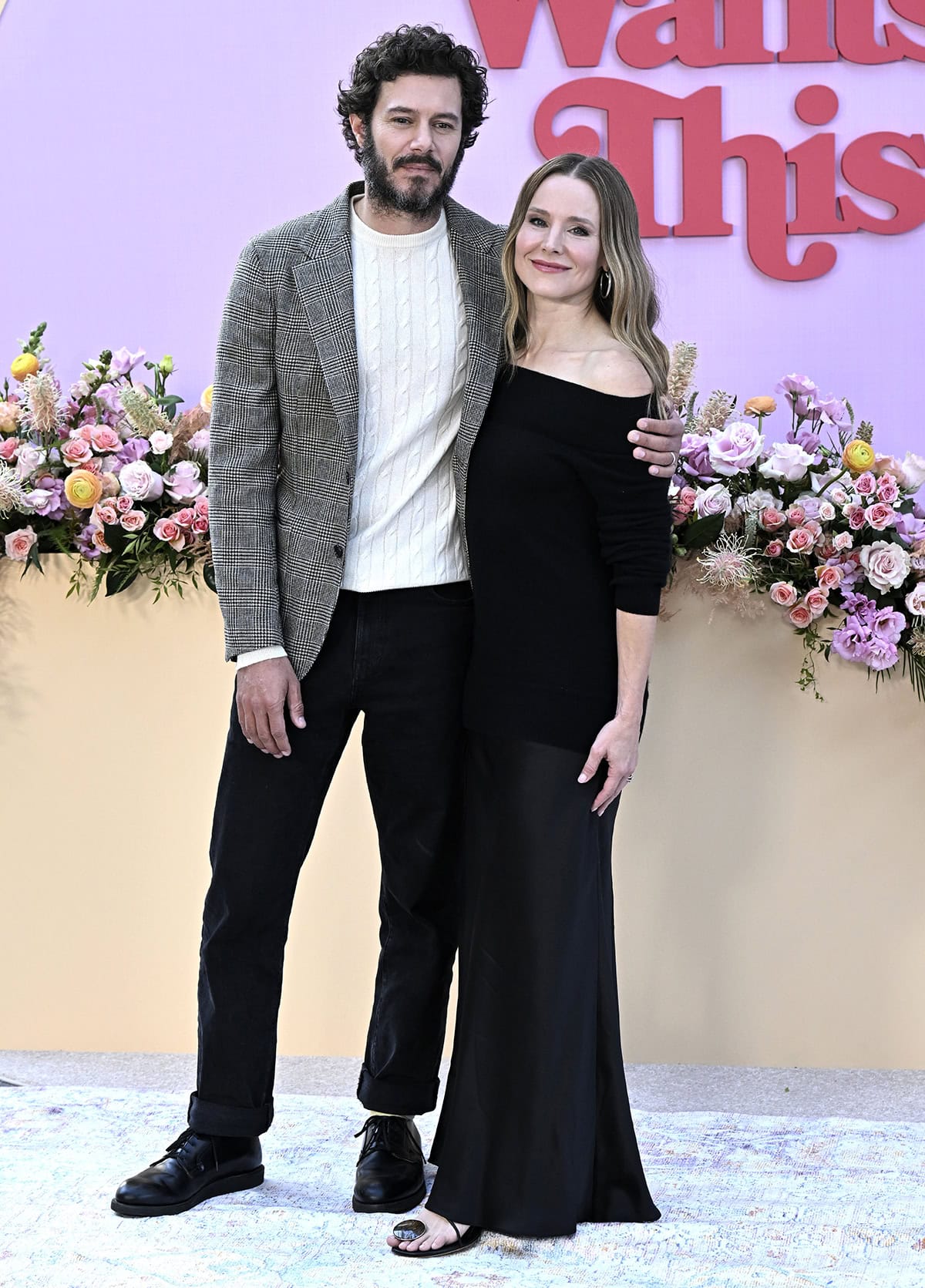 Kristen Bell exudes effortless sophistication in an off-the-shoulder black Christopher Esber dress and minimalist strappy sandals as she poses with Adam Brody at Netflix’s Nobody Wants This FYC event at the Tudum Theater in Los Angeles on November 7, 2025