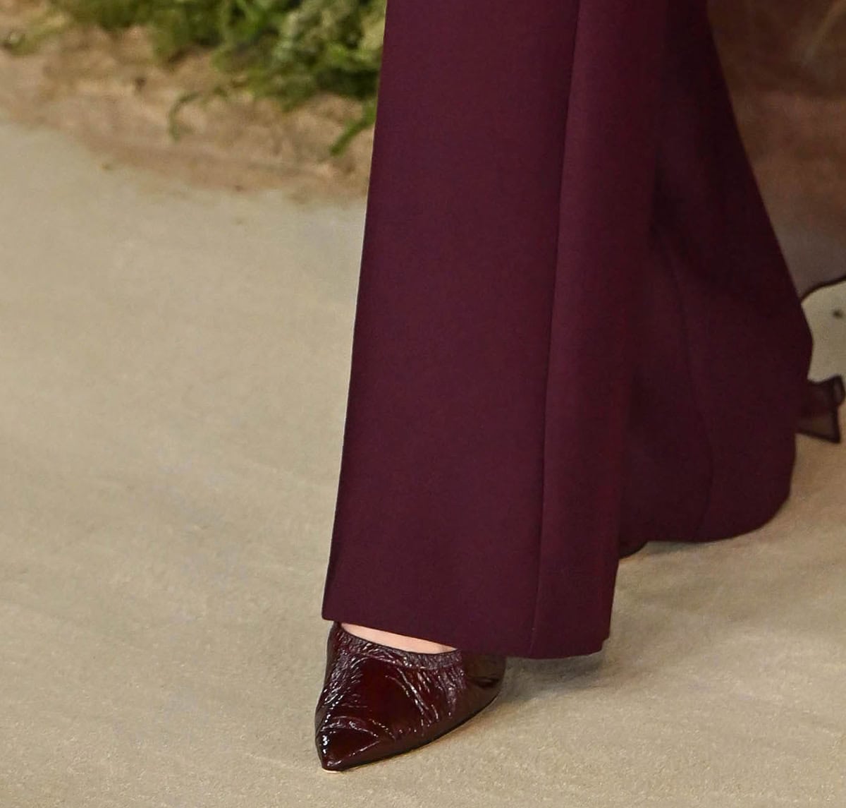 Ali Larter adds shine to her burgundy ensemble with matching pointy pumps made from shiny textured leather