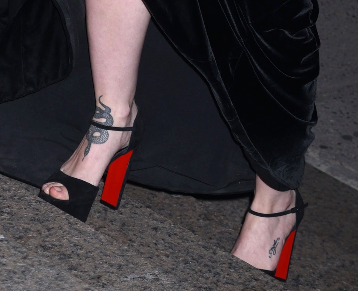 Dove Cameron shows off her foot tattoos in black suede Christian Louboutin "Sandaloo" sandals with platforms and wide heels
