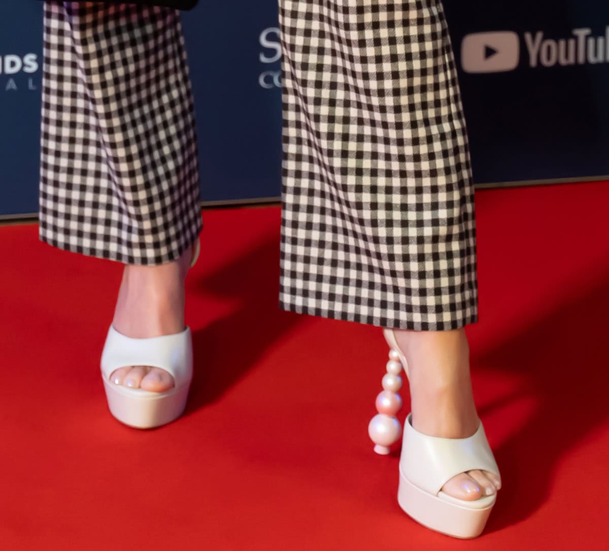 Emma Bunton elevates her classic tailoring with Sophia Webster's "Natalia Perla" open-toe sandals featuring platforms and heels made of graduating pearlized beads