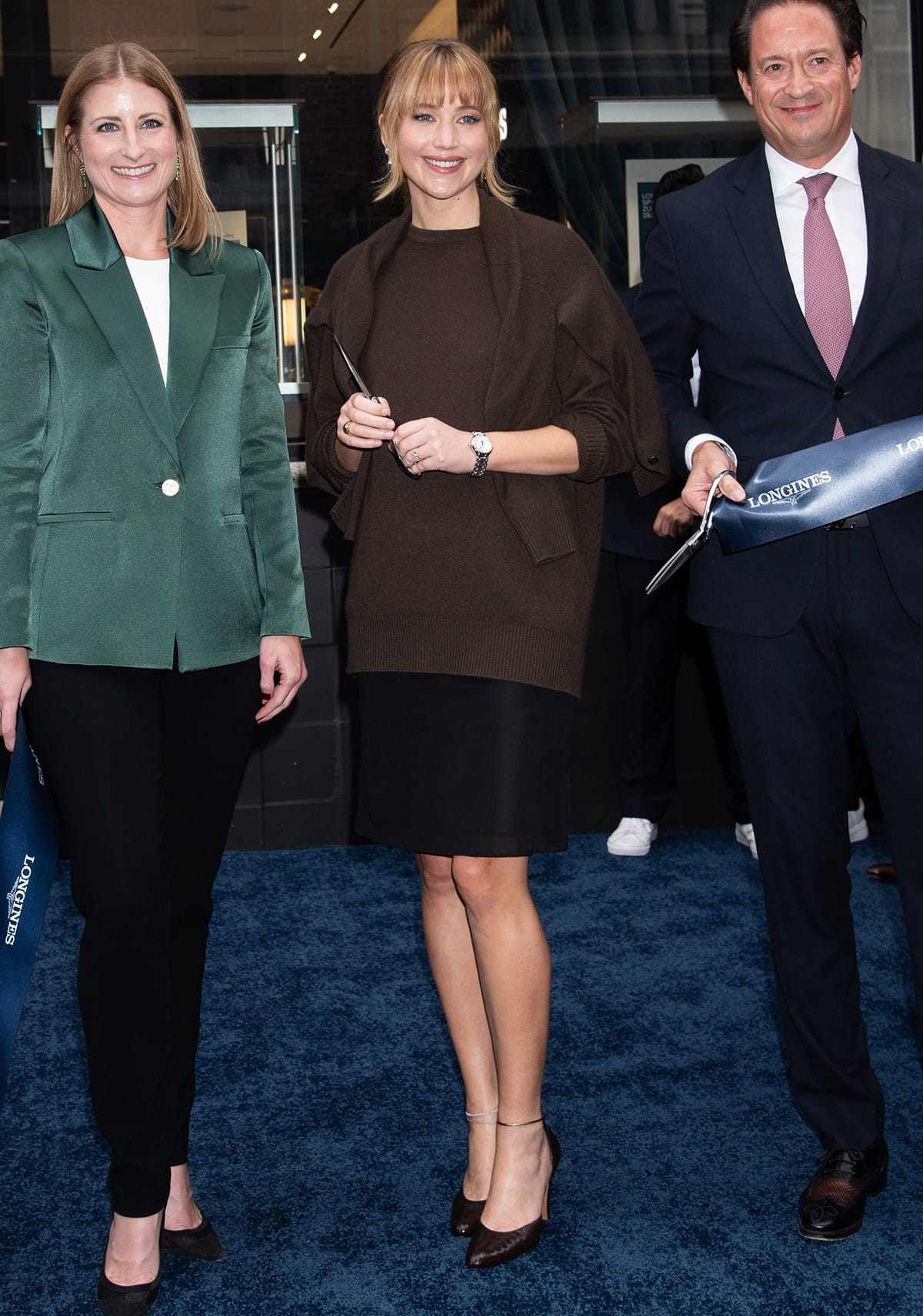 Jennifer Lawrence attends the Longines ribbon-cutting event in a brown sweater and black mini skirt combination from The Row's Spring 2026 collection