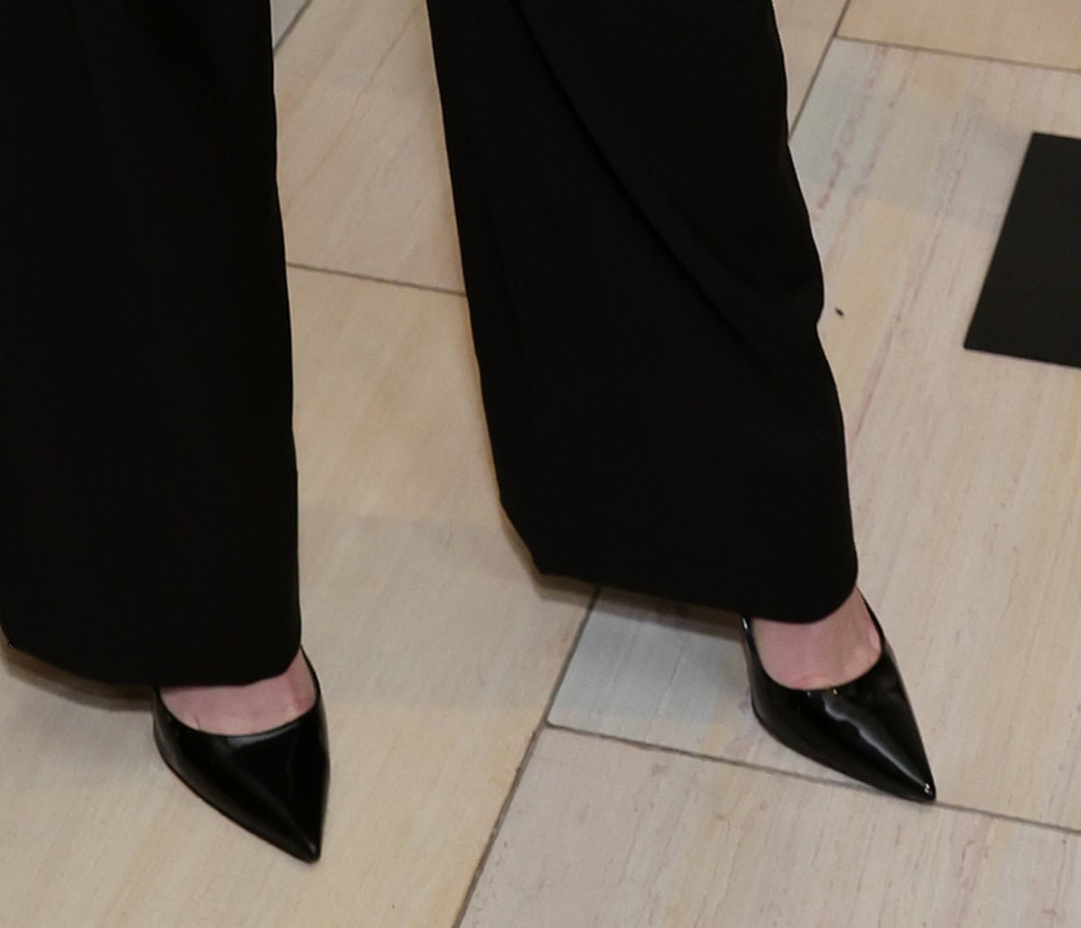 Kiernan Shipka completes her more professional red-carpet outfit with classic black pointy pumps