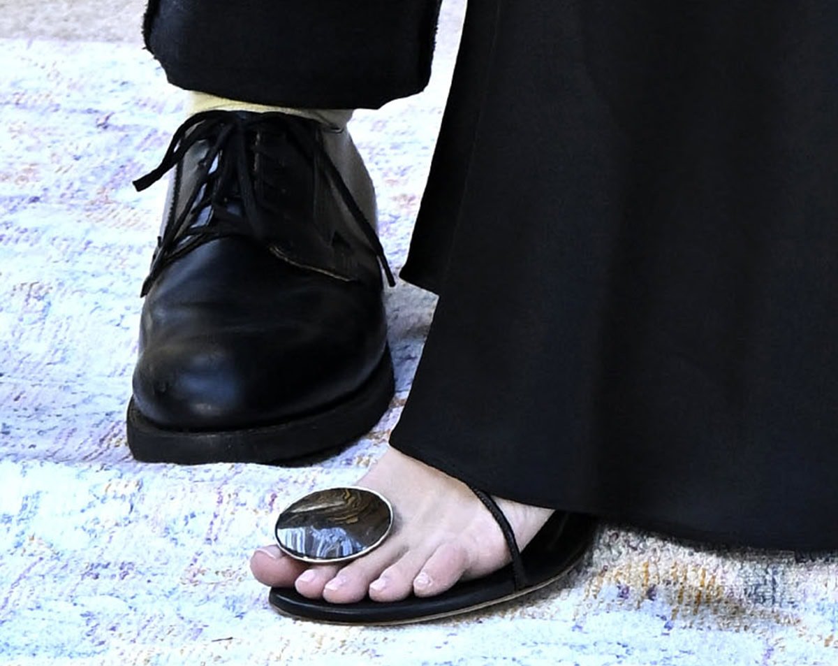 Kristen Bell completes her laid-back but chic ensemble with summery black sandals by Christopher Esber featuring a strappy upper with a tiger's eye stone accent