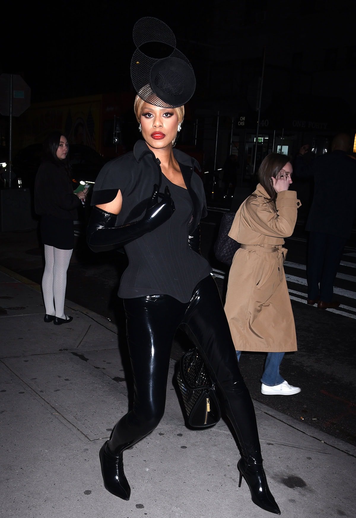 Laverne Cox commands attention in an edgy, all-black Mugler corset and glossy Garo Sparo pantaboots at the premiere of A Very Jonas Christmas Movie at New York City Center on November 10, 2025