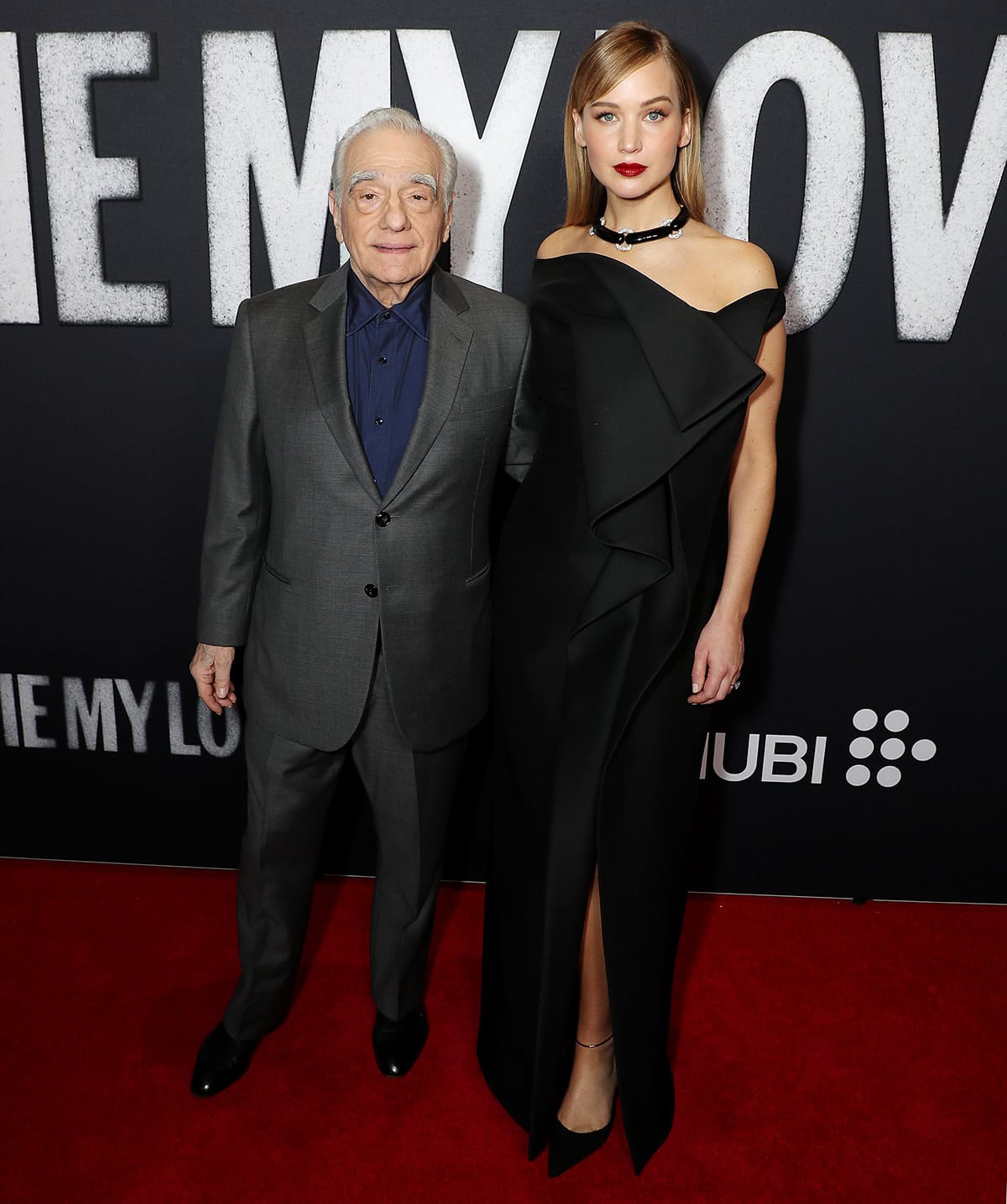 Jennifer Lawrence exudes sculptural sophistication in an off-shoulder black gown with a cascading ruffle detail and pointed black pumps as she joins producer Martin Scorsese at the Die My Love New York premiere at AMC Lincoln Square Theater on November 1, 2025