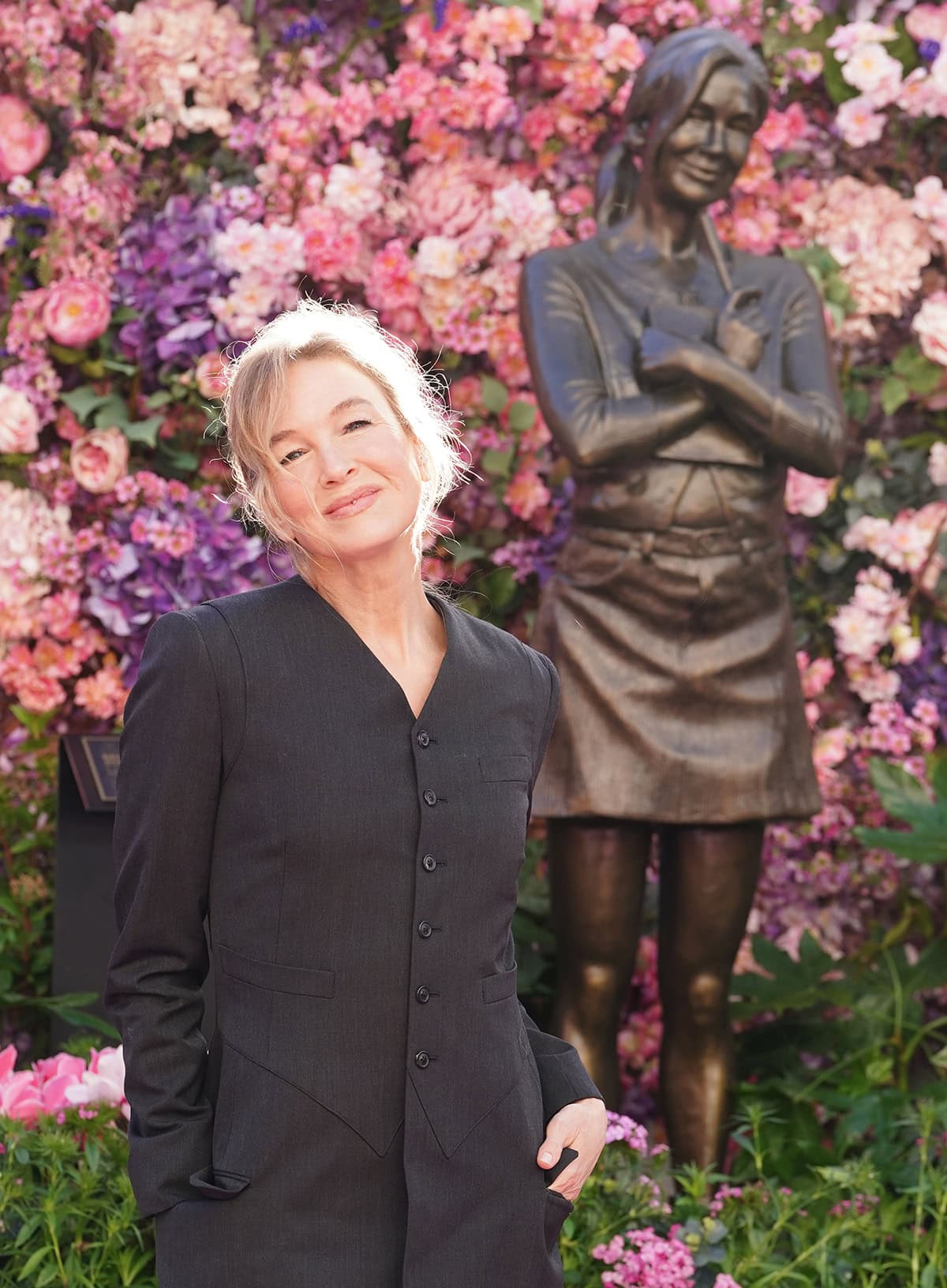 Renée Zellweger keeps her look elegant with minimal soft pink makeup and a loose ponytail