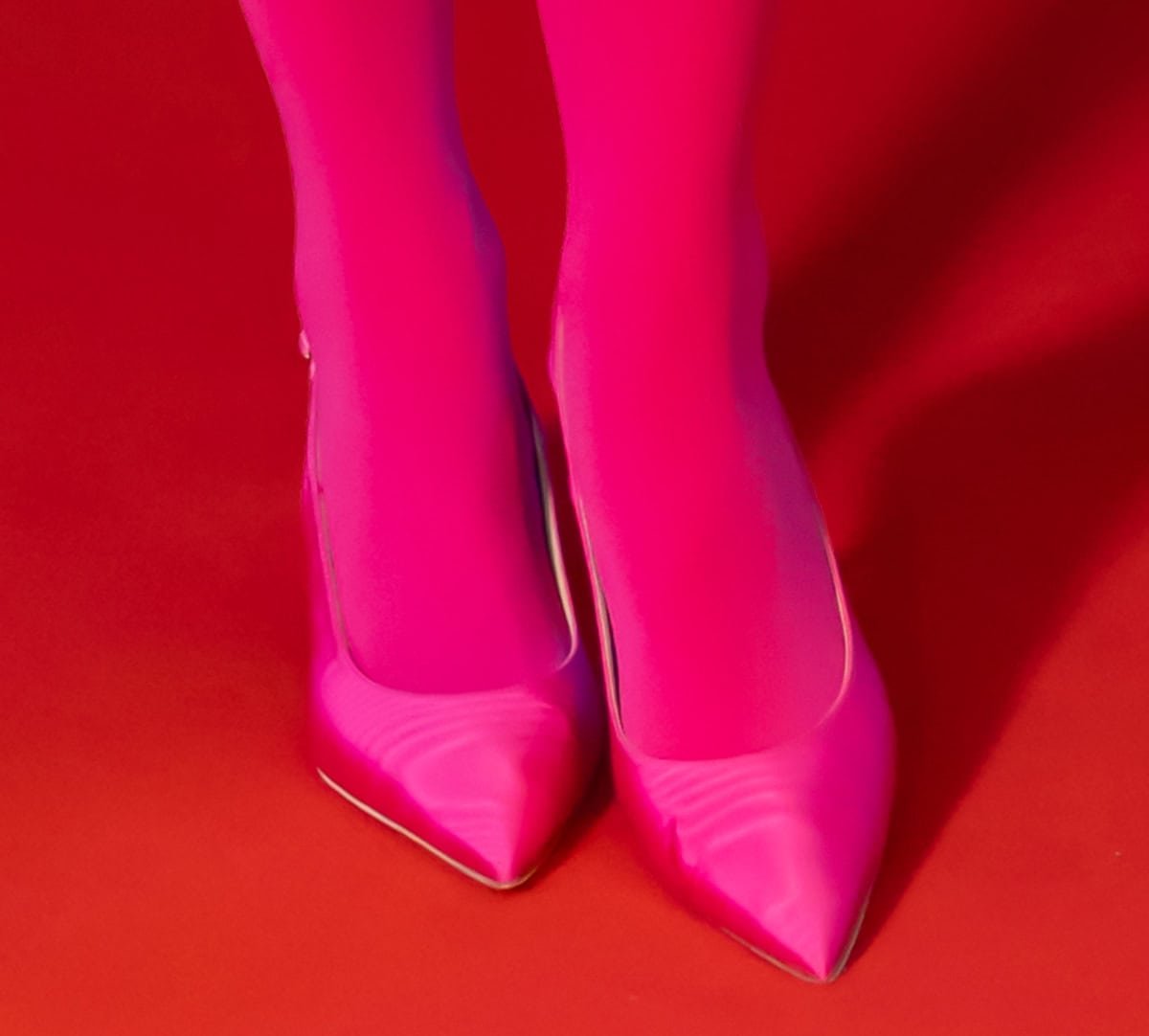 Rita Ora proves Barbiecore is still thriving as she wears hot pink tights with matching hot pink Russell & Bromley "Hillcliffe" slingback pumps