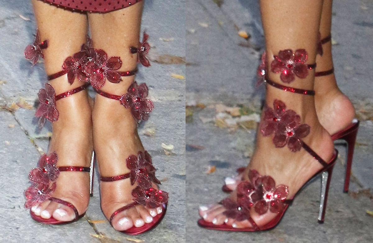 Vivica A. Fox completes her monochromatic burgundy red look with René Caovilla heels featuring crystal-encrusted straps and crystal flowers
