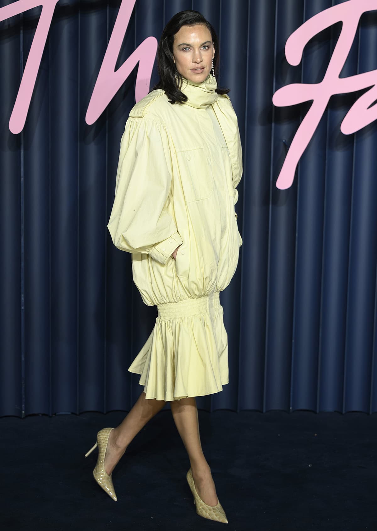 Alexa Chung keeps things cohesive by teaming her shoes with a pale-yellow Chloe dress made of trench-style fabric