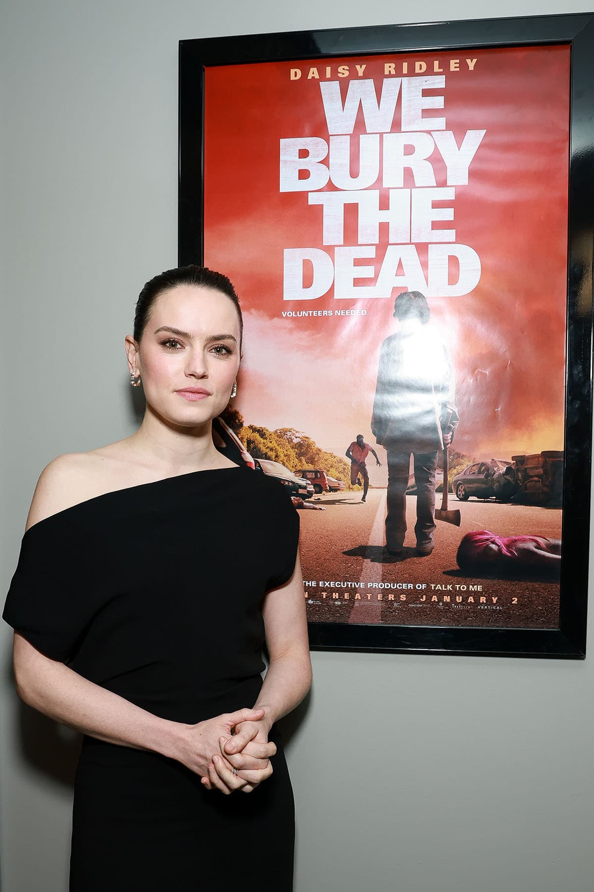 Daisy Ridley blends classic elegance with modern edge at the New York screening of We Bury the Dead, pairing a black Proenza Schouler asymmetrical dress with black knee-high boots