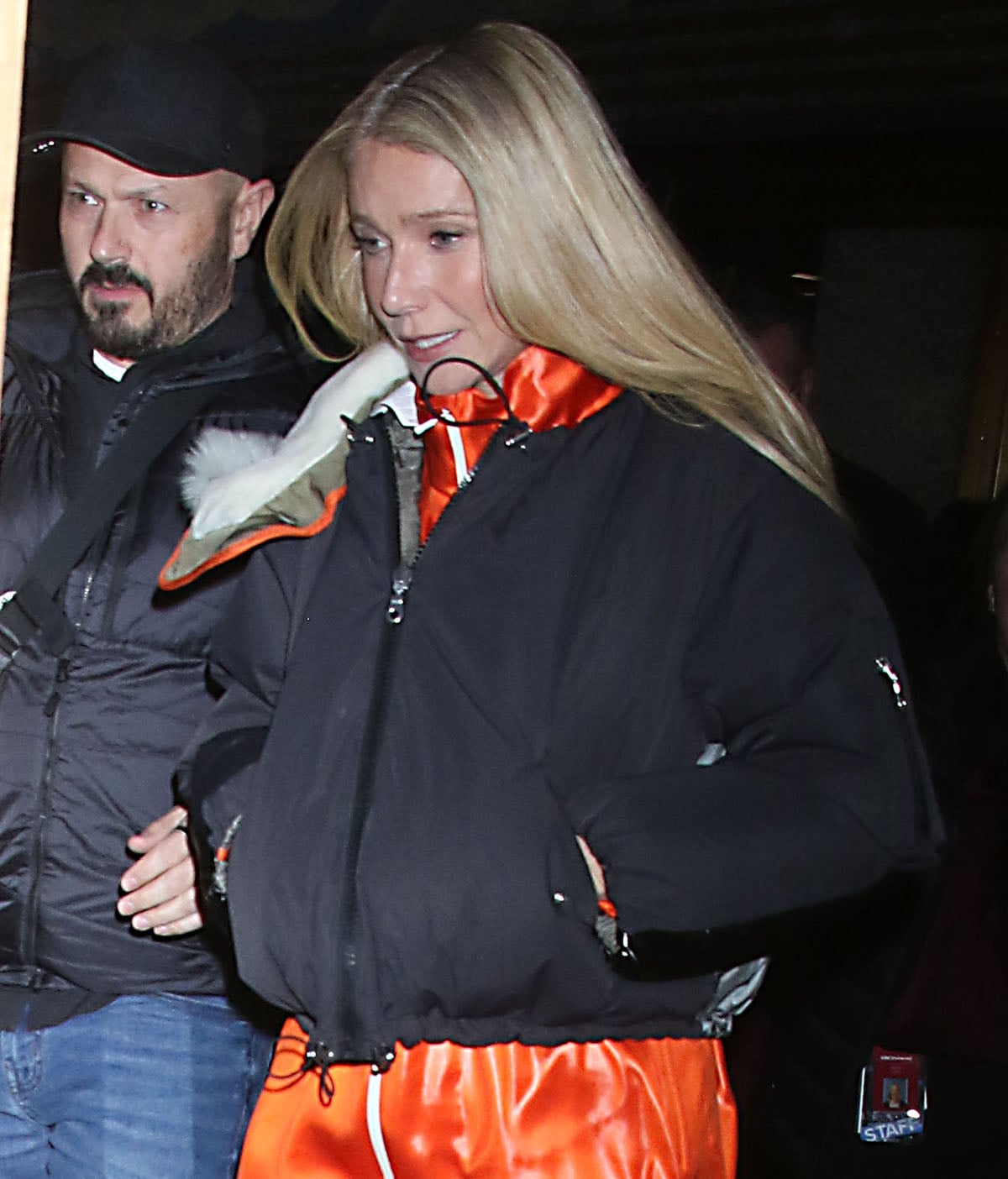 Gwyneth Paltrow teams her white adidas shoes with an orange Lacoste tracksuit as a playful nod to the neon ping pong balls tied to the film’s story