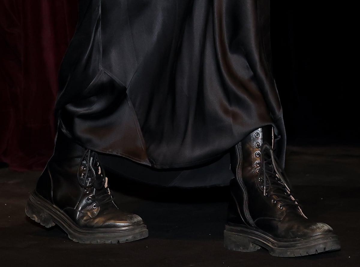 Jenna Ortega pairs her sultry slip dress with rugged combat boots, injecting a tough-chic element to her feminine look