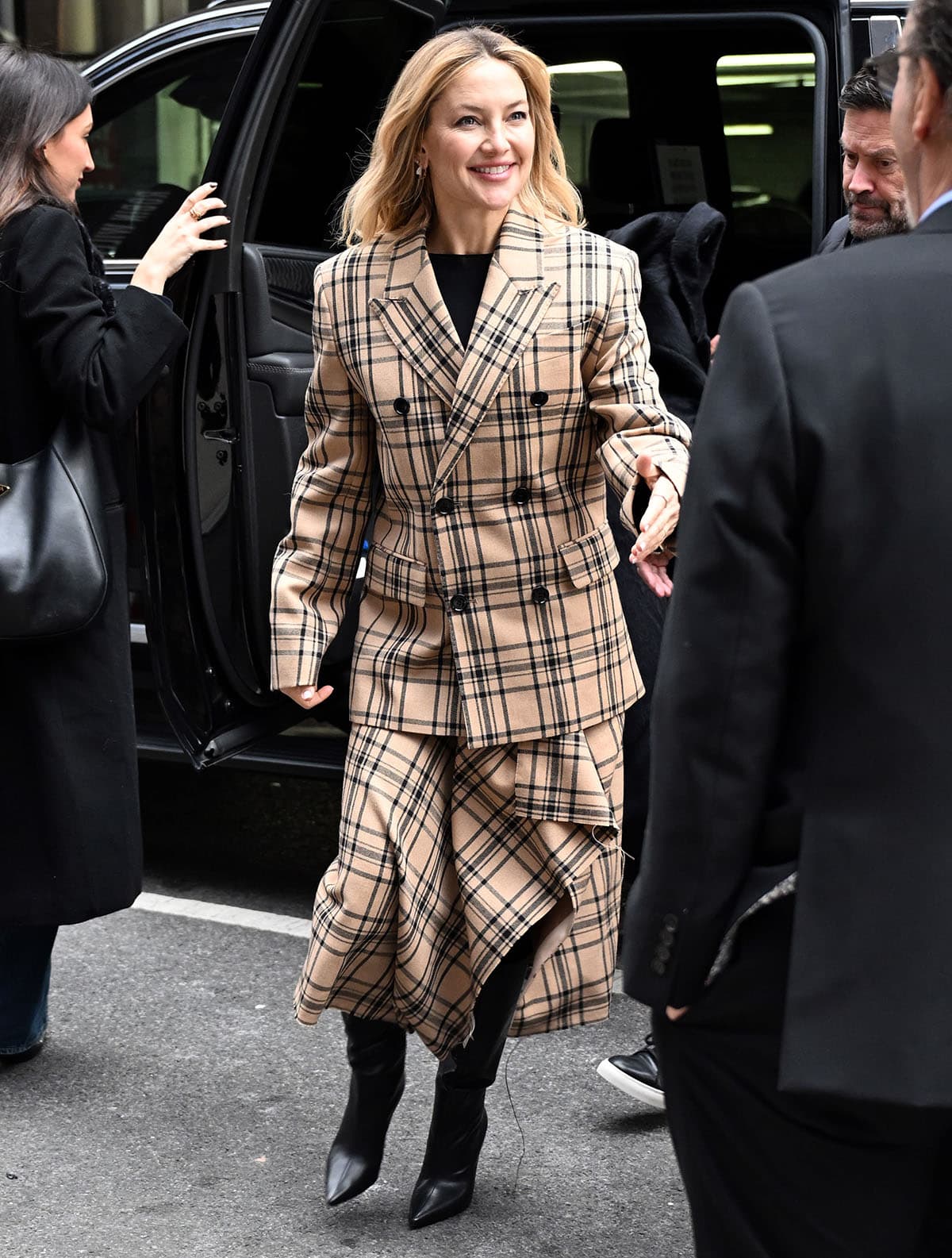 Kate Hudson looks cozy in her oversized camel-and-brown check-print jacket and matching midi skirt with an asymmetrical hem from Ami Paris at the Q&A screening of Song Sung Blue at the Robin Williams Center–SAG-AFTRA Foundation