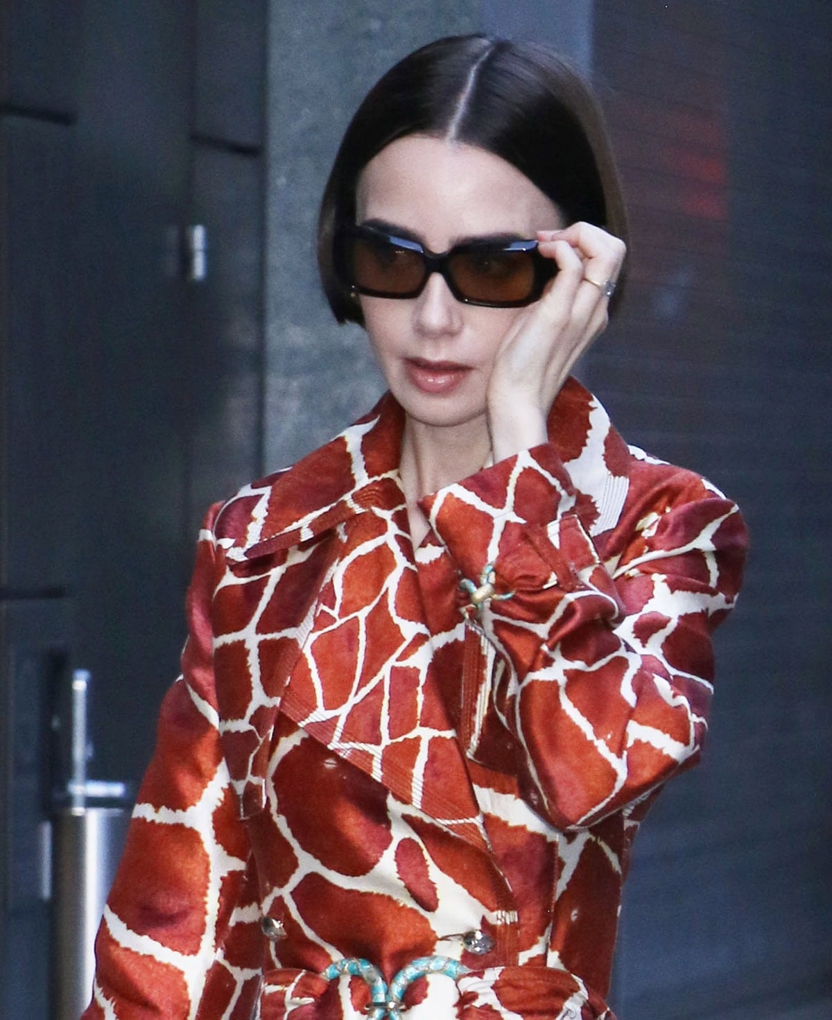 Lily Collins adds a sleek, modern finish to her vintage ensemble by styling her bob sleek and straight and wearing a pair of Phoebe Philo sunglasses