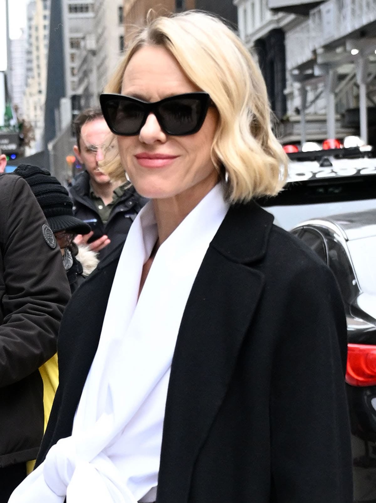 Naomi Watts styles her business-ready Saint Laurent ensemble with sleek Alexander McQueen Spike Geometric cat-eye sunglasses