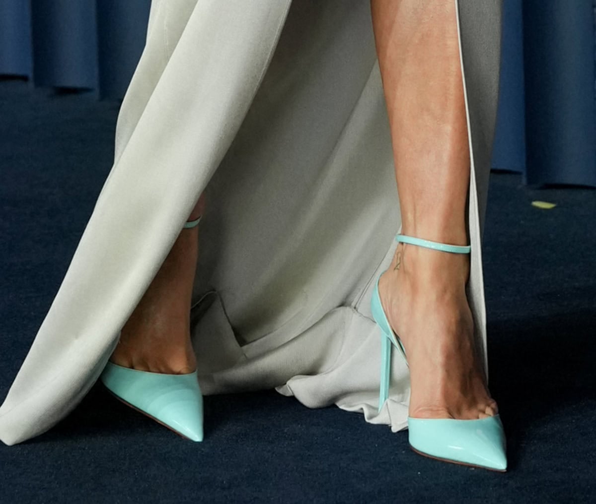 Rita Ora adds a striking pop of color with robin-egg-blue Tom Ford pumps peeking through her gray gown’s front slit