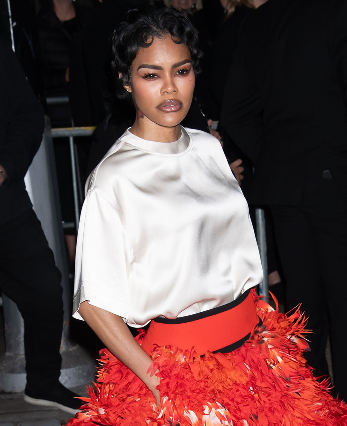Teyana Taylor wears her pixie hair in curls and accentuates her striking features with smoky eyeshadow and two-toned lip gloss