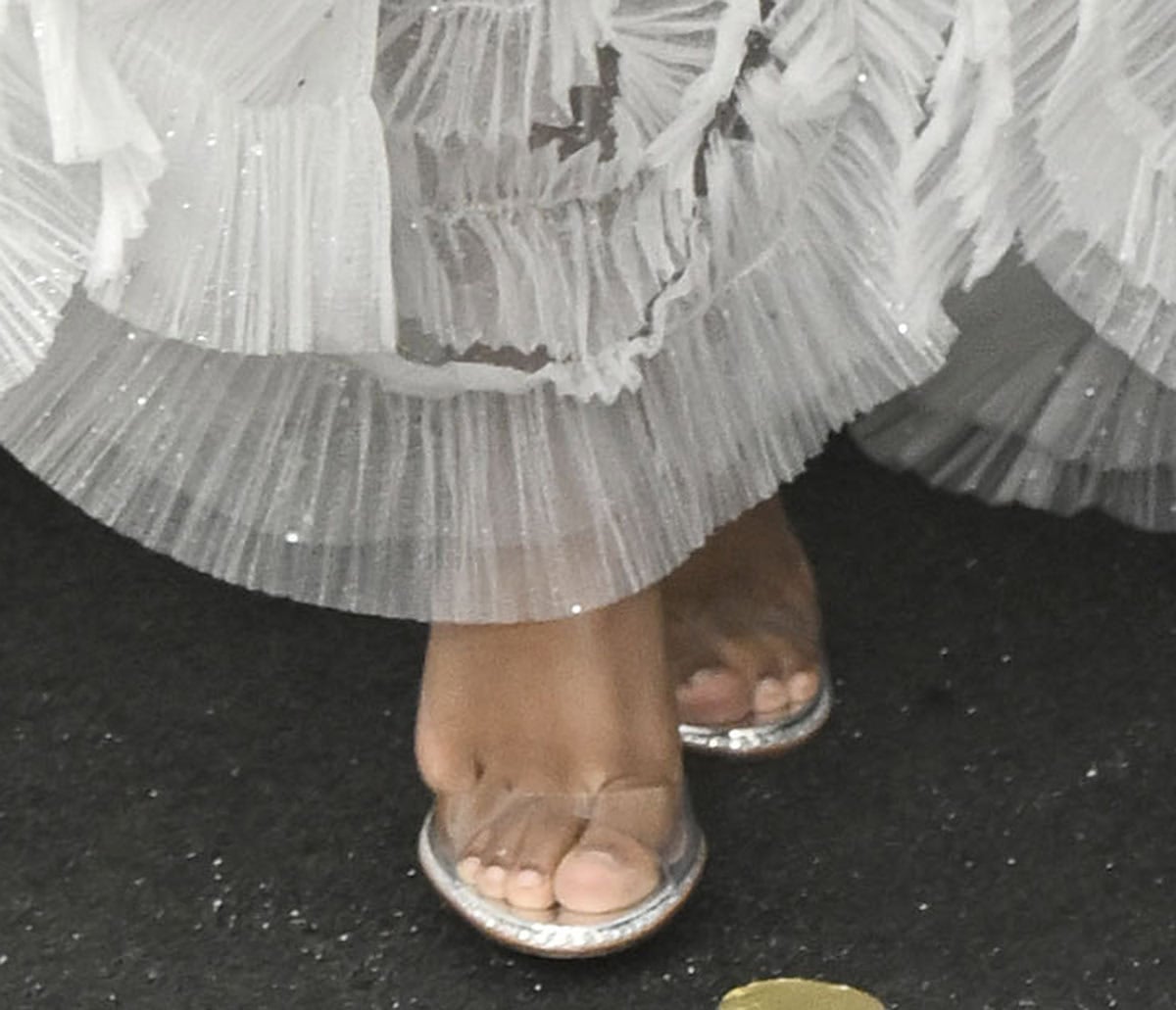 Aliyah Mastin pairs her already stunning white gown with minimalist silver heels with a clear PVC front strap