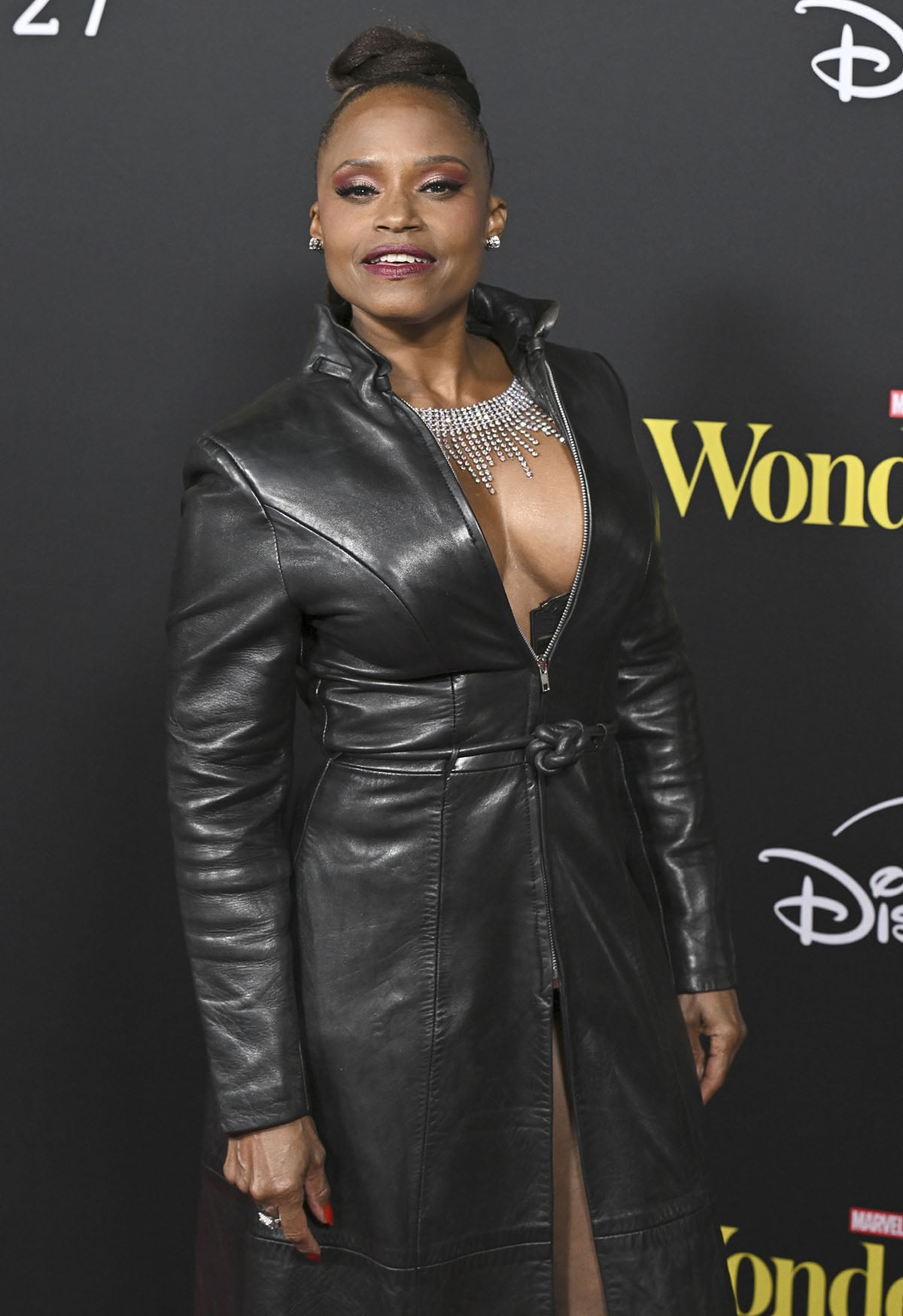 Cassandra Creech brings serious edge to the red carpet, pairing her plaid crystal boots with a black leather trench coat