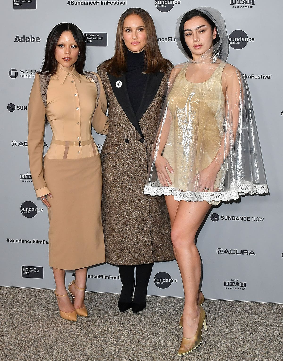 Jenna Ortega, Natalie Portman, and Charli XCX in matching neutral outfits at the premiere of The Gallerist during the 2026 Sundance Film Festival at Eccles Center Theater in Park City, Utah
