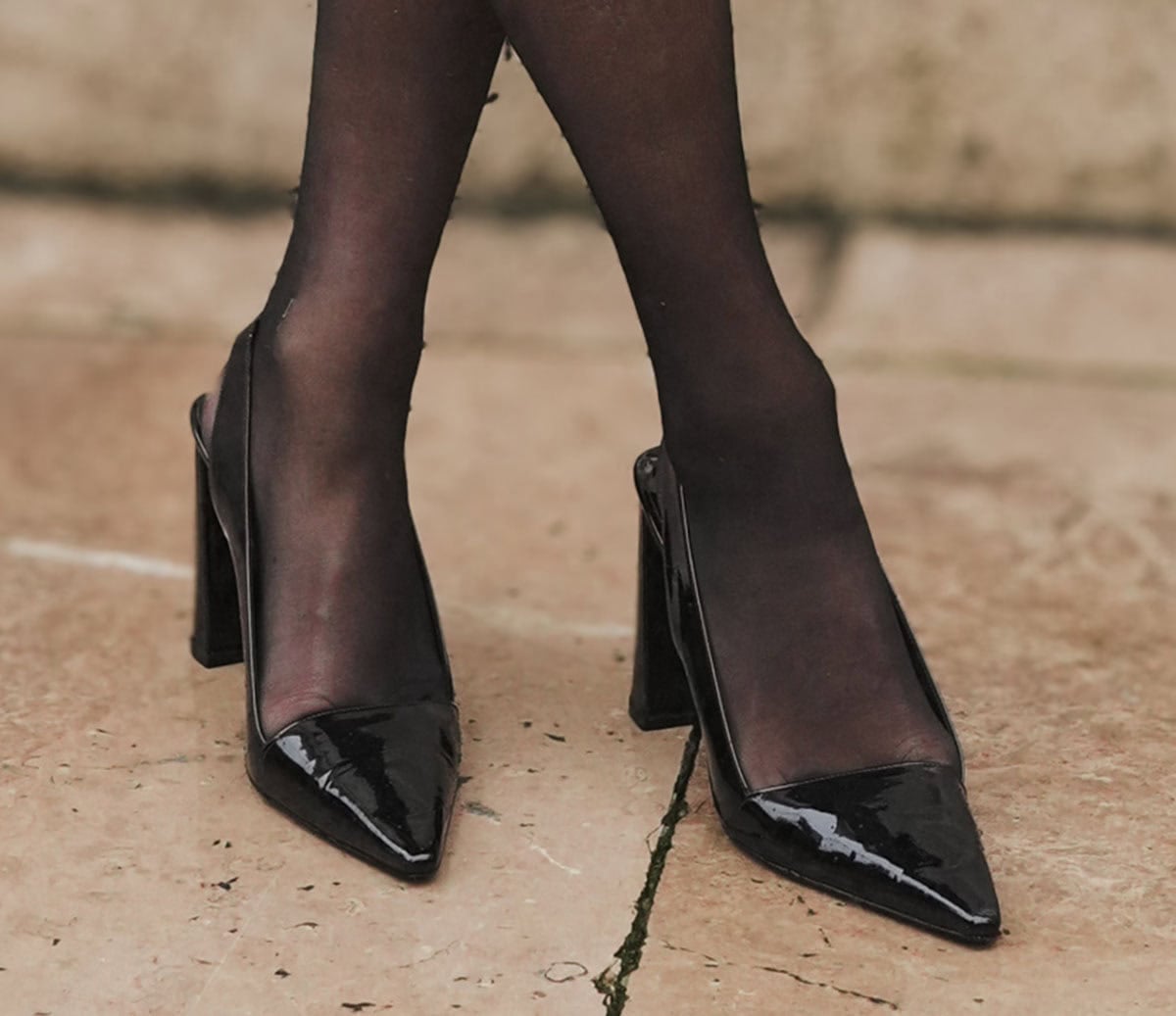 Kelly Piquet embraces retro style, wearing black stockings with shiny black pointed-toe slingback pumps by Patou
