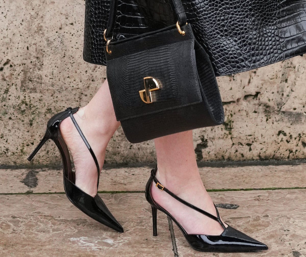 Lili Reinhart slips into the Giuseppe Zanotti “Almha” pumps with a Y-shaped strap, a pointed toe, and a stiletto heel