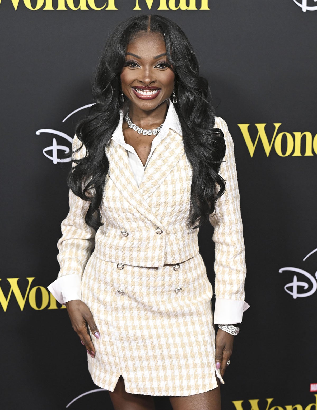 Loren Lott teams her silver crystal bow shoes with a beige houndstooth skirt suit featuring a cropped blazer and a mini skirt with pearl buttons