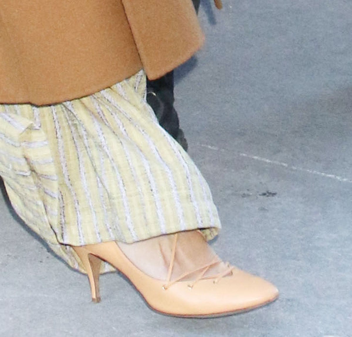 Rebecca Hall slips into the nude Ulla Johnson “Lola” ballerina pumps featuring lace-up ties that crisscross over the foot and wrap around the ankles