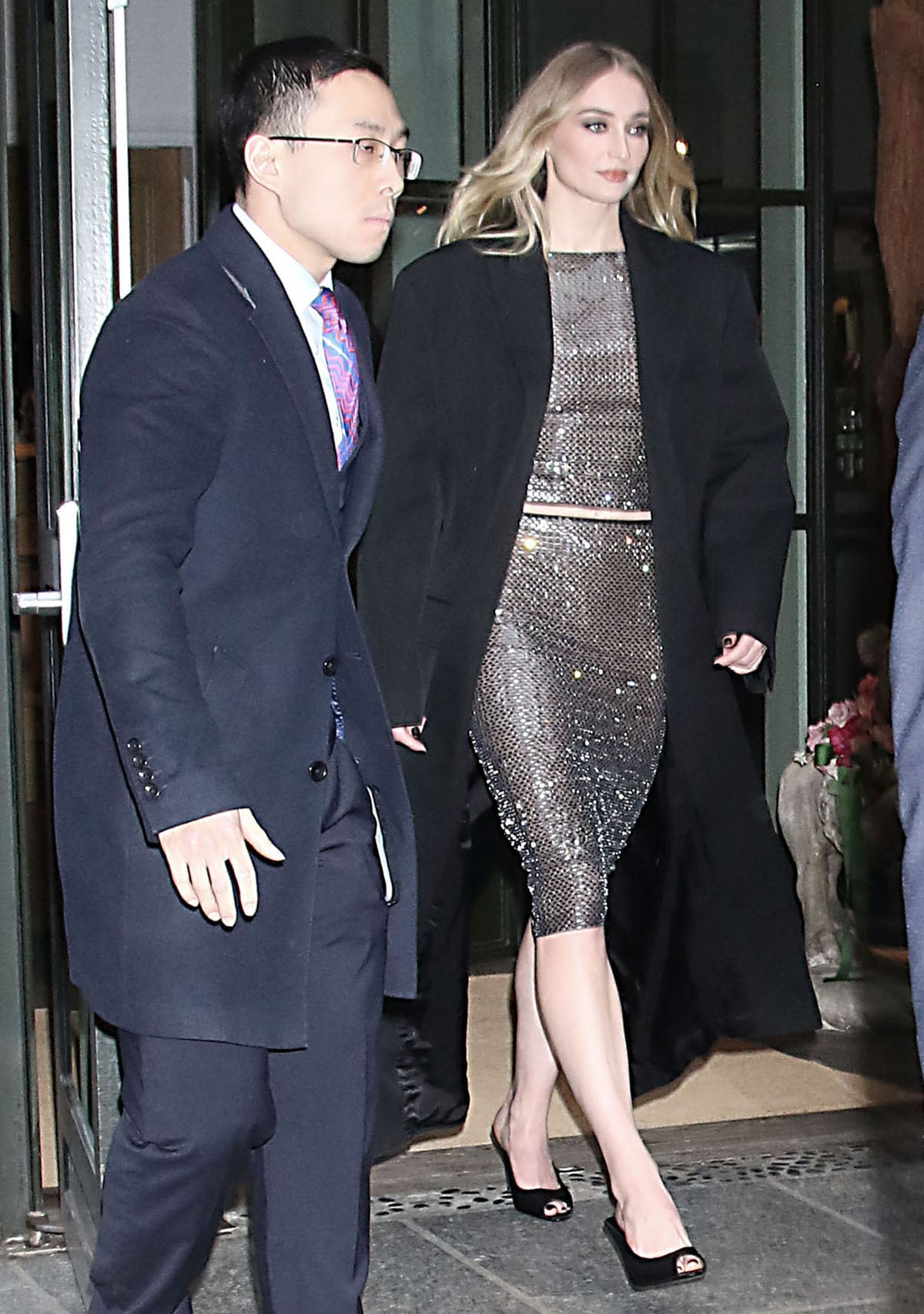 Sophie Turner sparkles in her Self-Portrait outfit featuring a long-sleeved crop top and a pencil midi skirt adorned with rhinestone embellishments outside The Tonight Show Starring Jimmy Fallon studios