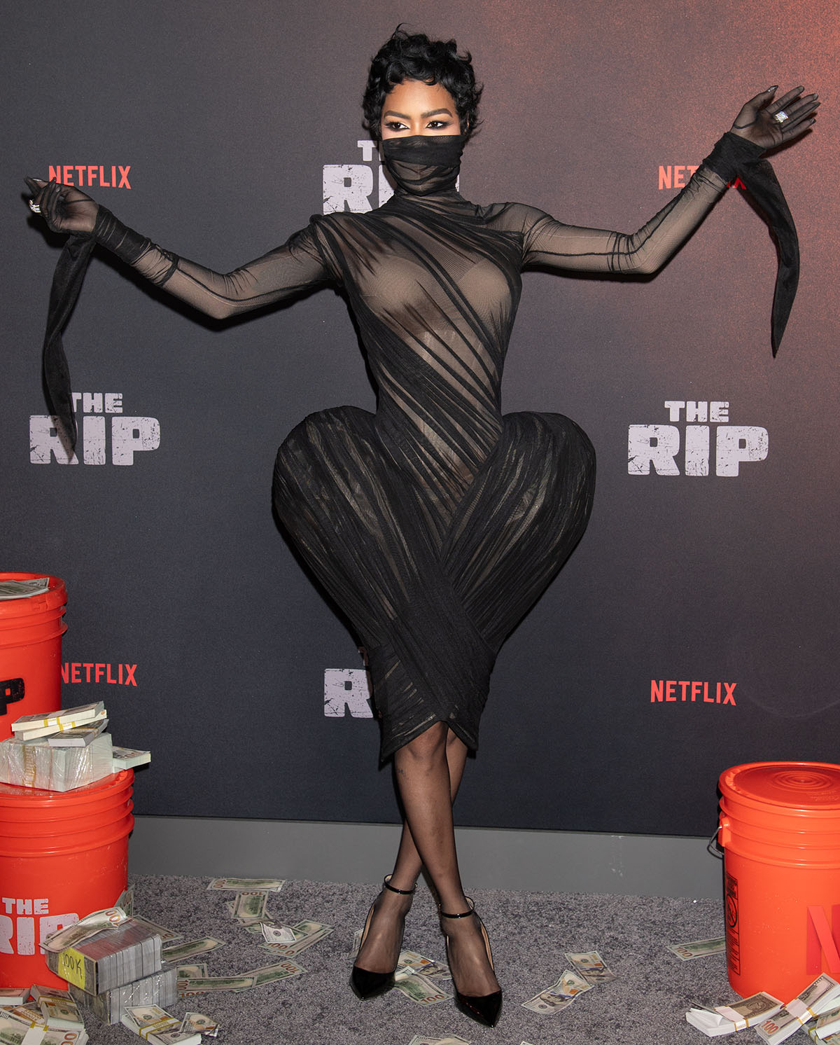 Teyana Taylor makes a grand entrance in a sheer black Ashi Studio dress and black Aquazzura pumps at the world premiere of The Rip at Alice Tully Hall