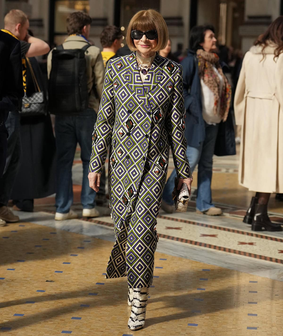 Anna Wintour commands Milan Fashion Week in an archival Prada geometric coat and white striped snakeskin knee-high boots
