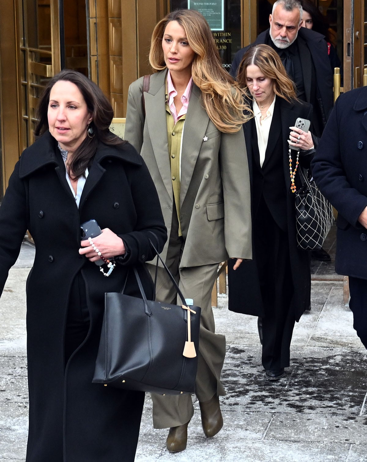 Blake Lively power dresses in an olive green suit with matching boots outside a New York City courthouse following a settlement conference in her lawsuit against It Ends With Us co-star Justin Baldoni