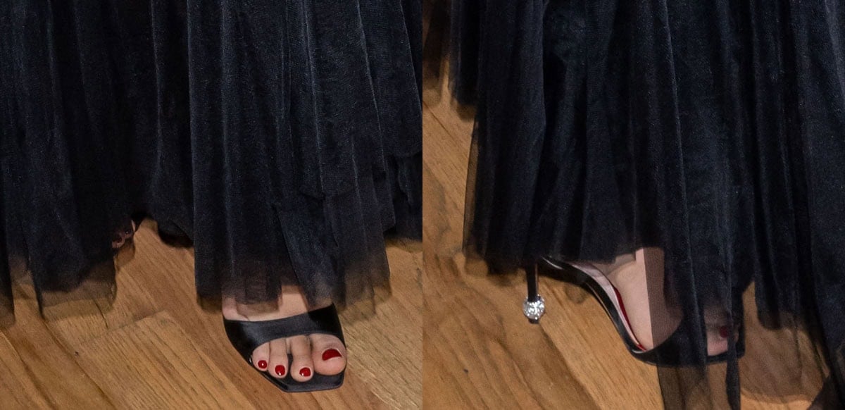 Camila Mendes completes her look with a red pedicure and black satin Roger Vivier “Marlene” sandals with a crystal sphere at the heel