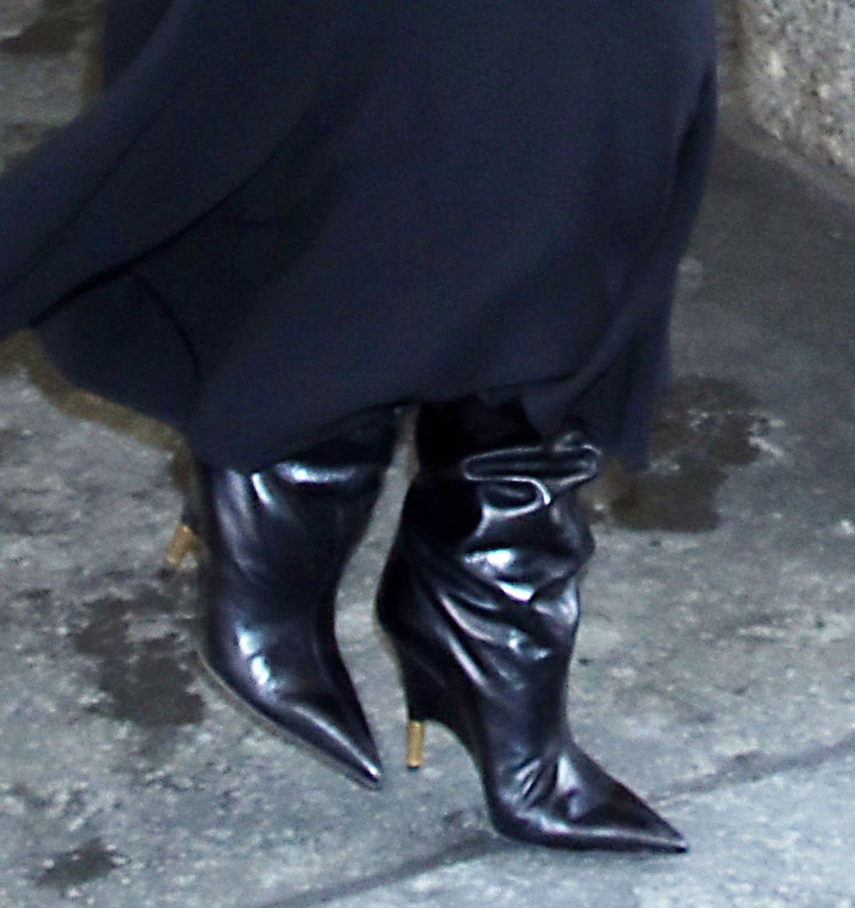 Camila Morrone steps out at New York Live! wearing sleek black Khaite “Bella” knee-high boots, their slouchy shafts, pointed toes, and sculptural heels adding quiet edge to her all-black look