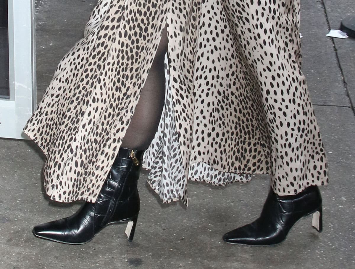 Constance Zimmer slips her feet into the Le Seul “Amaryllis” black embossed gator boots featuring square toes, ankle straps, side zips, and sculpted heels