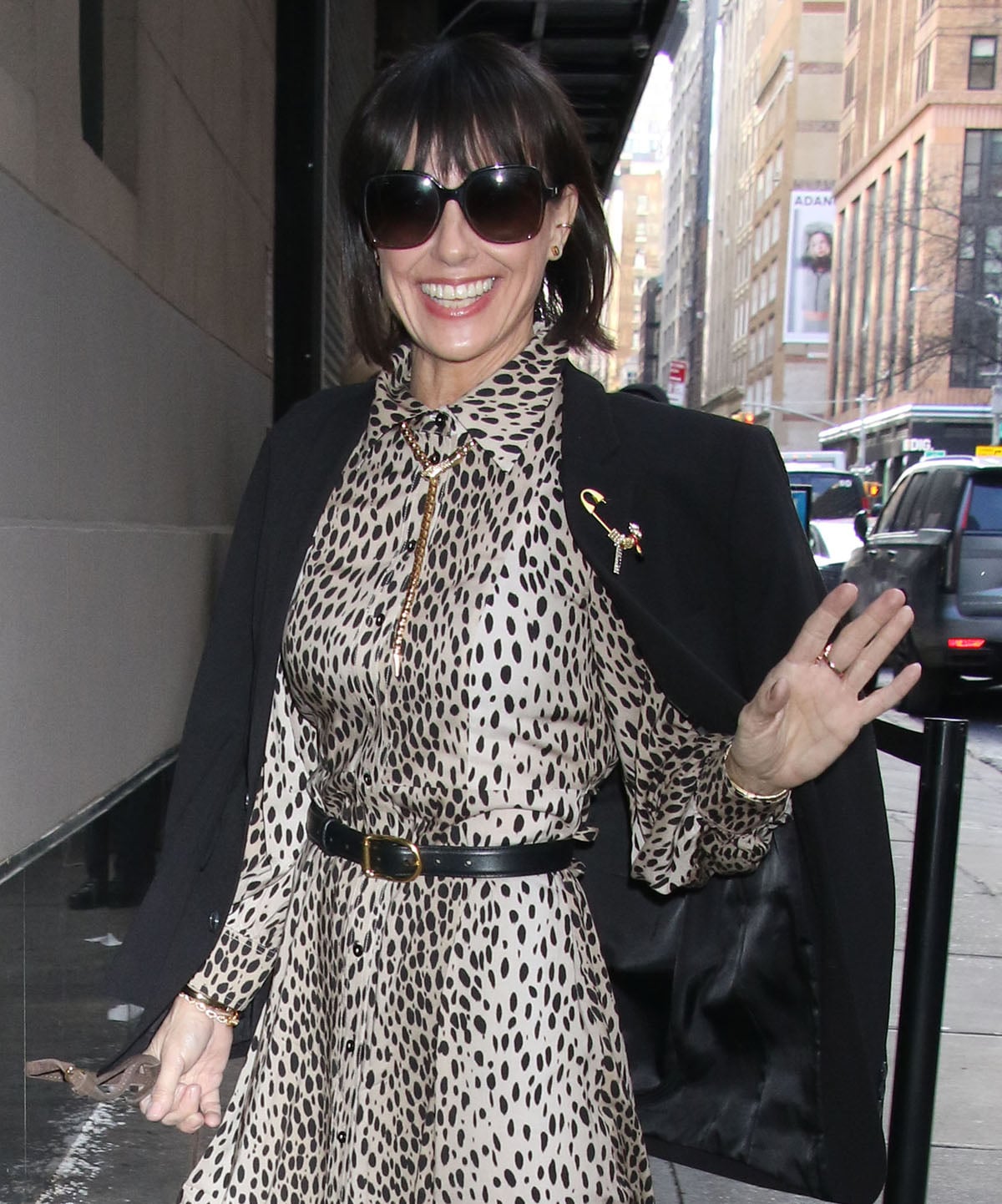 Constance Zimmer styles her look with gold jewels and shields her eyes behind oversized square sunglasses