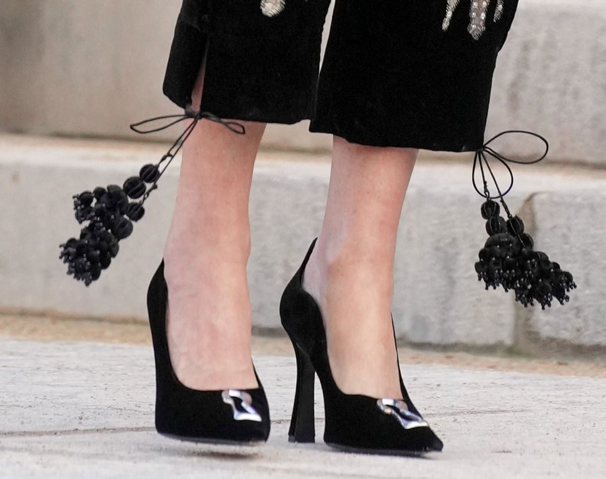 Demi Moore slips into a pair of Schiaparelli Keyhole pumps in black velvet with a curved topline, a silver-tone keyhole detail, and slightly flared, thick heels