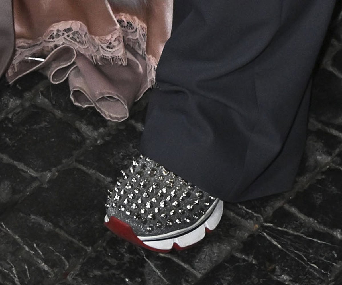 Diane Warren completes her gray suit with silver Christian Louboutin Spike Sock trainers featuring studs all over the upper and the label's signature red sole