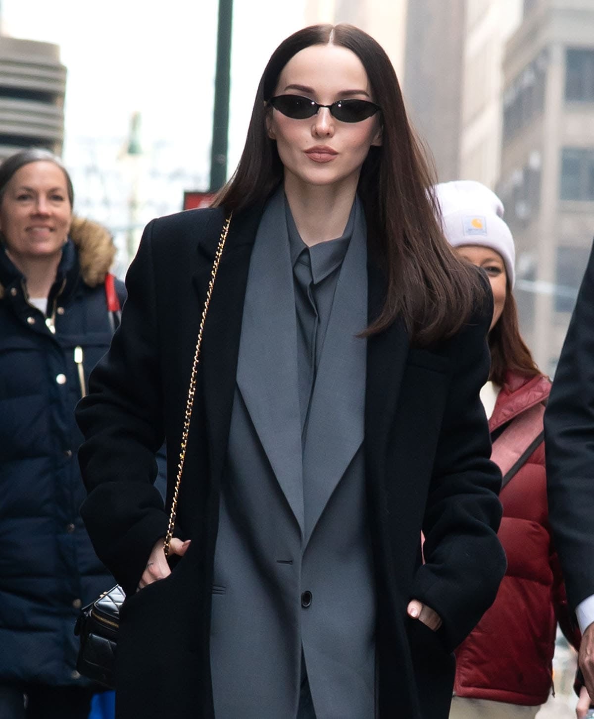 Dove Cameron styles her modern oversized tailoring with Gentle Monster sunglasses and a black Chanel Mini Vanity bag