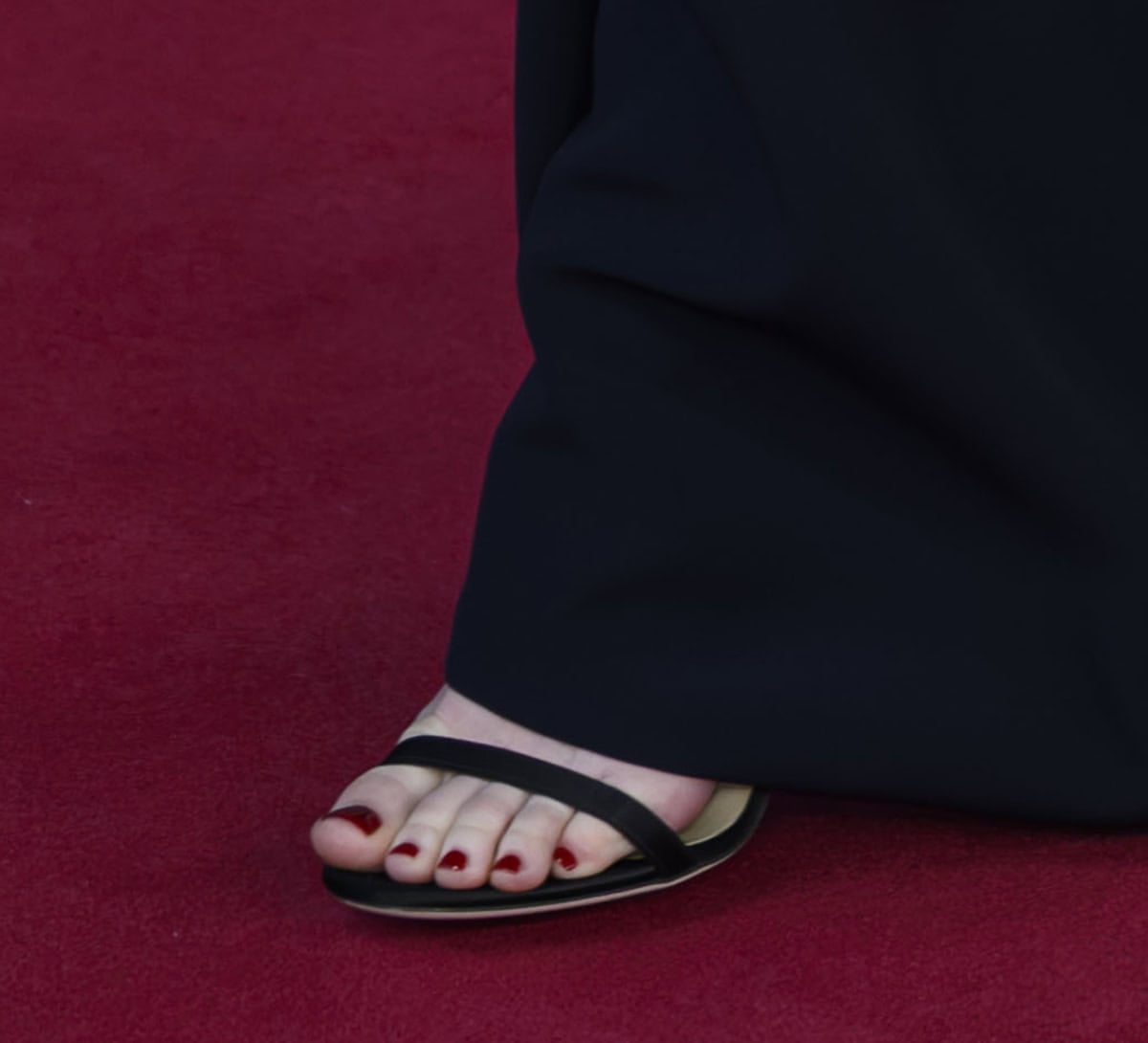 Emma Stone keeps her footwear understated, choosing the red-carpet favorite Jimmy Choo “Minny” sandals in black