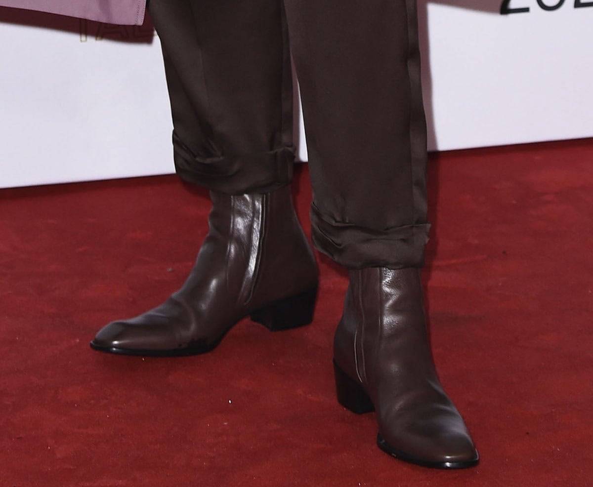 Gwendoline Christie completes her tailored look with the brown leather Saint Laurent “Stanton” ankle boots