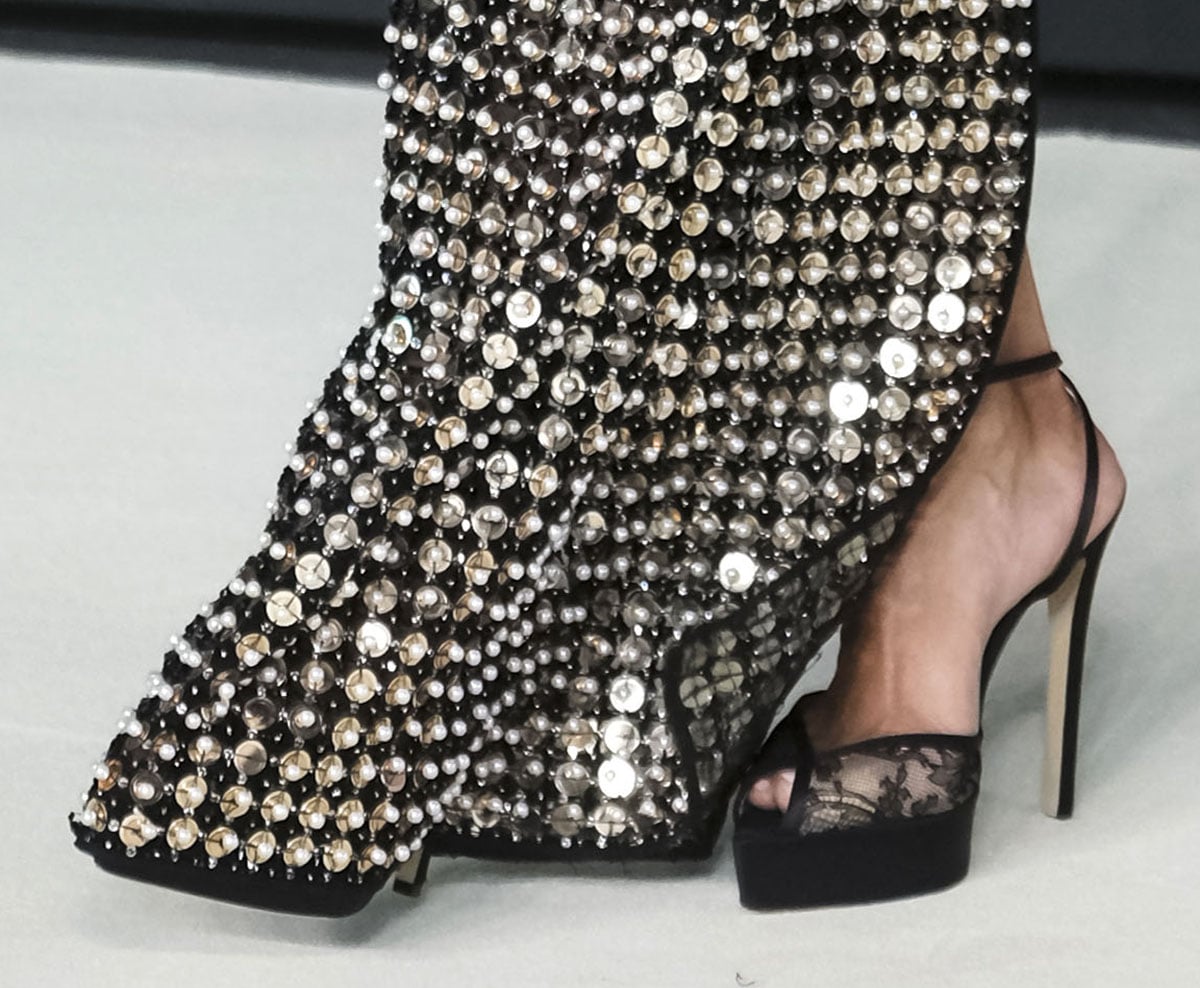 Halle Berry goes sultry from the ground up, slipping her feet into a pair of see-through floral lace sandals by Andrea Wazen