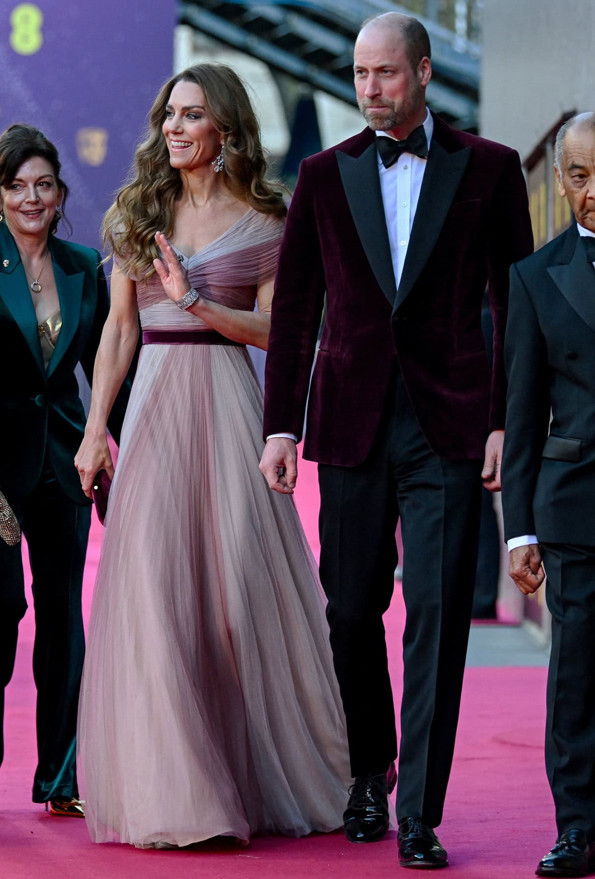 Kate Middleton rewears her custom berry-colored Gucci gown from 2019, while Prince William matches her in a red velvet Emporio Armani jacket