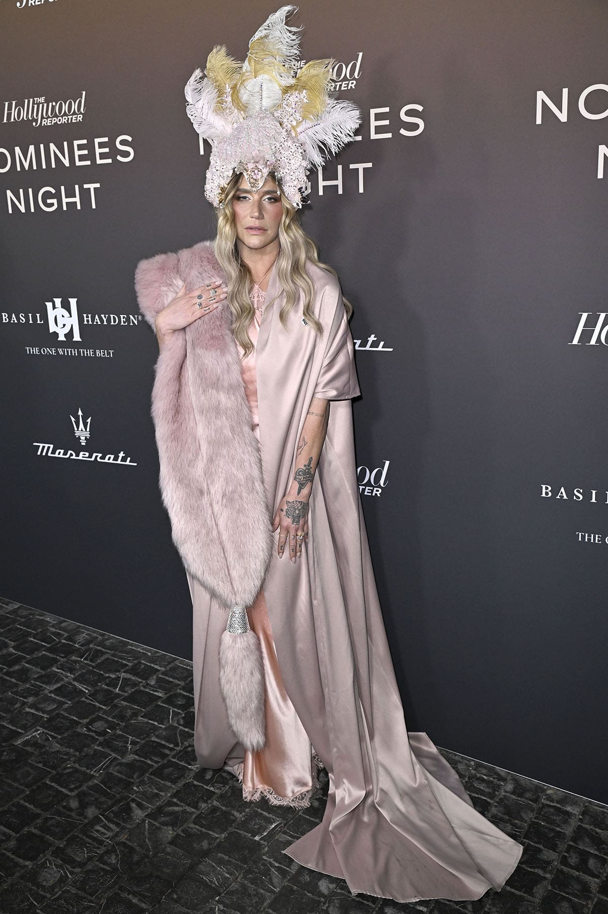 Kesha stands out in her pink Retrofête slip dress, with a Todd Fisher fur stole, and a Temptress Armory feather headpiece