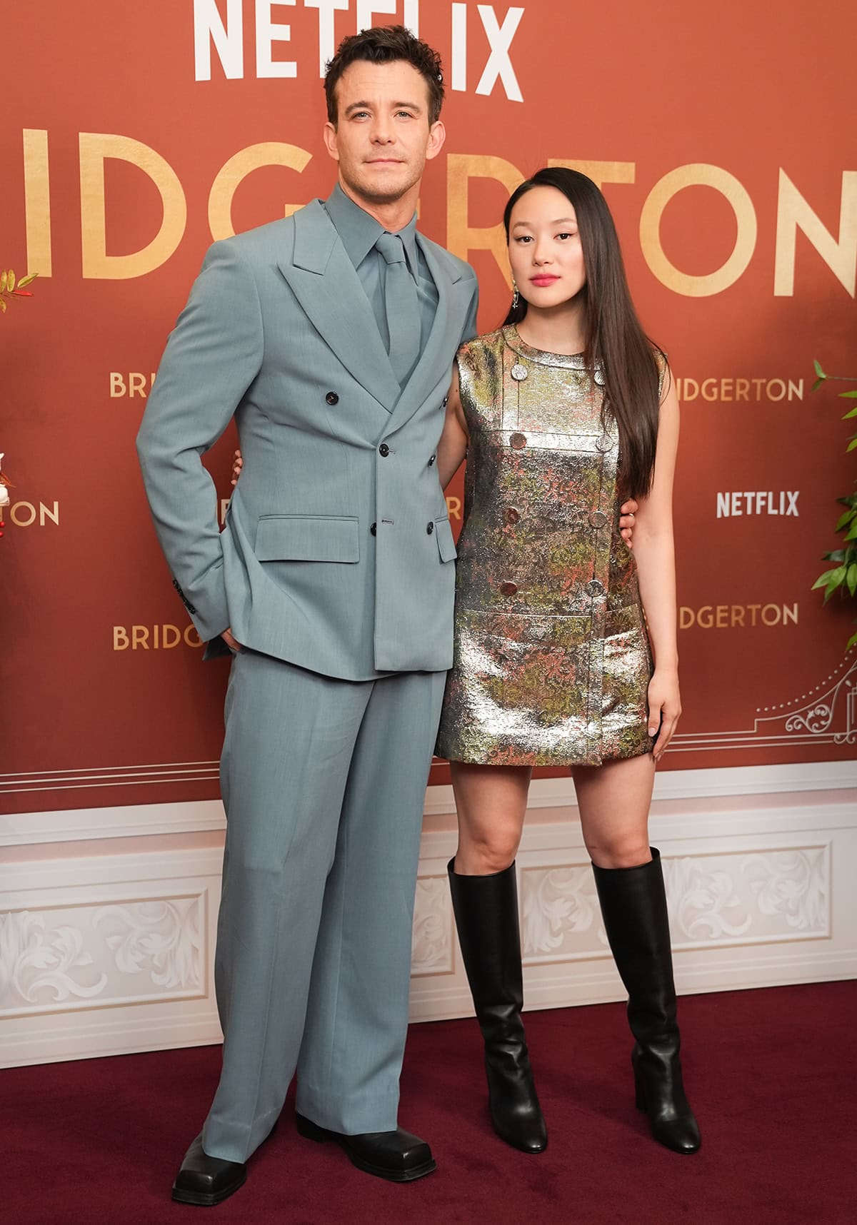 Luke Thompson and Yerin Ha attend the “Bridgerton” Season Four Part Two UK BFI Screening at BFI Southbank on February 24, 2026, in London, England, with the 5ft 1¼ actress adding height in sleek Louis Vuitton knee-high heeled boots beside her 5ft 11 co-star